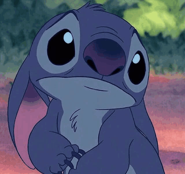 a close up of stitch from disney 's lilo and stitch with a sad look on his face
