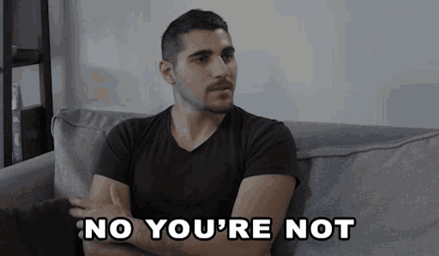 a man sitting on a couch with his arms crossed and the words no you 're not written below him
