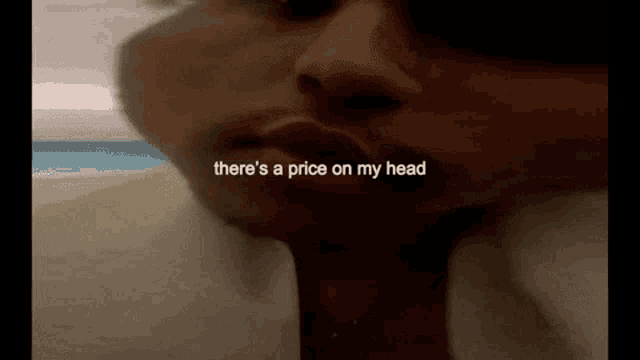 a close up of a person 's face with the words " there 's a price on my head " written above it