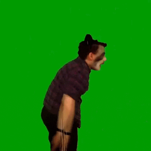 a man wearing a plaid shirt and face painted like a panda bear is standing in front of a green screen .