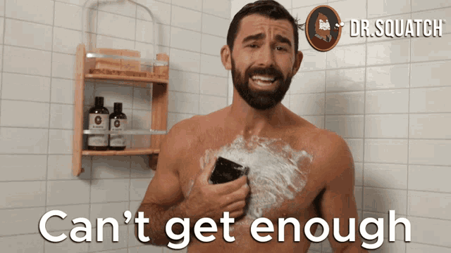 a shirtless man shaving in a shower with the words can 't get enough on the bottom