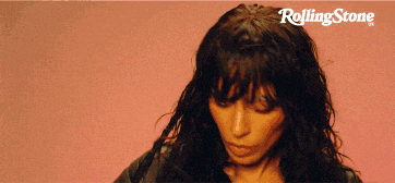a rolling stone ad with a woman in a black jacket