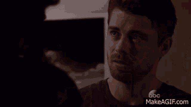 a man and a woman are looking into each other 's eyes with a makeagif.com watermark in the corner