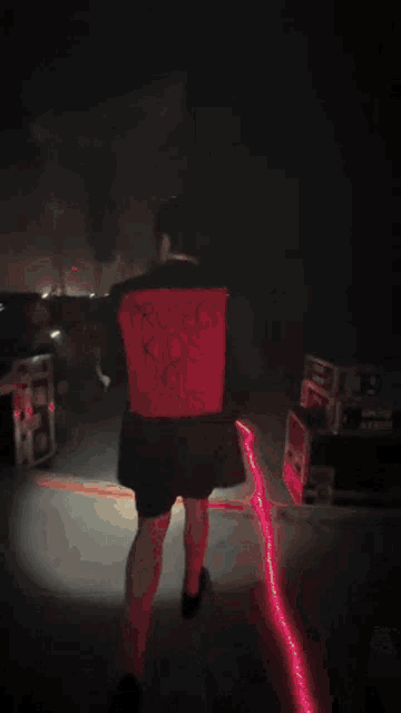 a blurred image of a person standing on a stage with a sign that says ' i love you ' on it