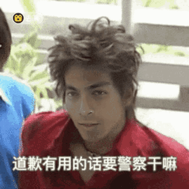 a man in a red shirt is making a funny face in a foreign language
