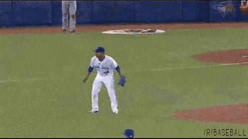 a baseball player wearing a blue jays uniform is standing on a baseball field .
