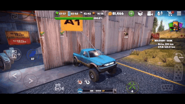 a blue truck is parked in front of a wall with a sign that says a1