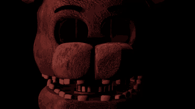 a close up of a teddy bear 's face with a dark background