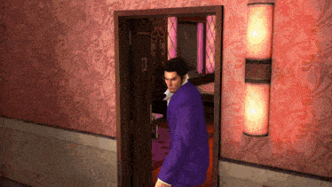 a man in a purple suit stands in a doorway