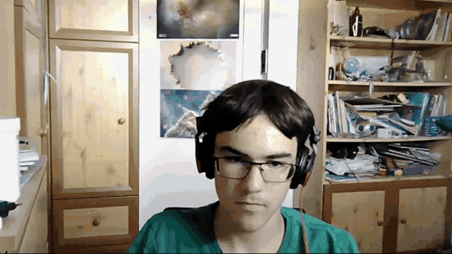 a man wearing headphones looks at the camera