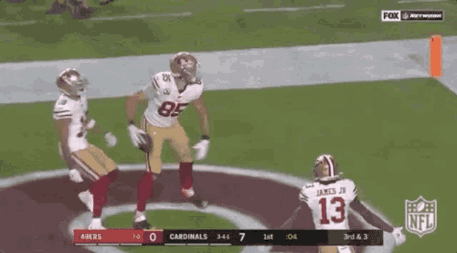 a football game is being played between the 49ers and the cardinals on fox network .