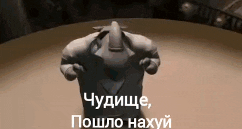 a statue of a man in a suit is standing in a circle with a caption in a foreign language .
