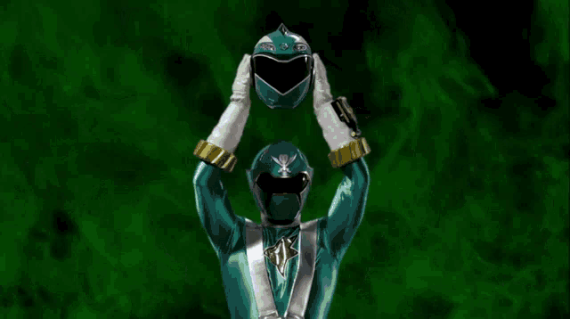 a green power ranger is holding his helmet in front of a green background