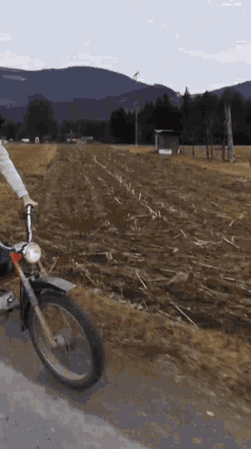 a person is riding a motorcycle on a dirt road