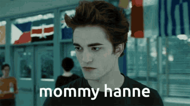 a man in a black shirt with the words mommy hanne written on his face