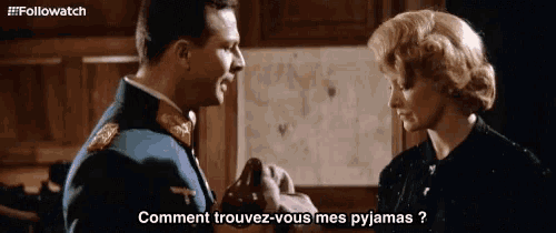 a man in a military uniform is talking to a woman in a black dress who is asking how to find their pyjamas