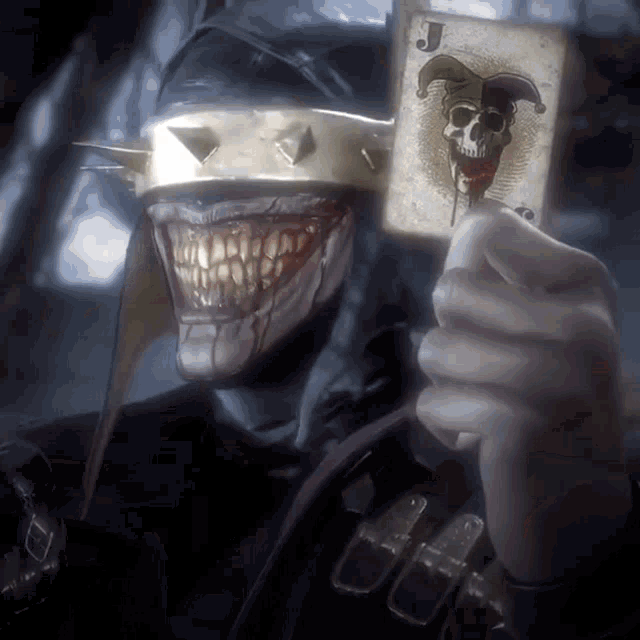 joker holding a card with a skull and jester on it