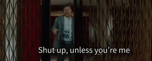 a man is kneeling on the floor in a room and says `` shut up , unless you 're me '' .