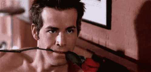 a man is holding a rose in his mouth .