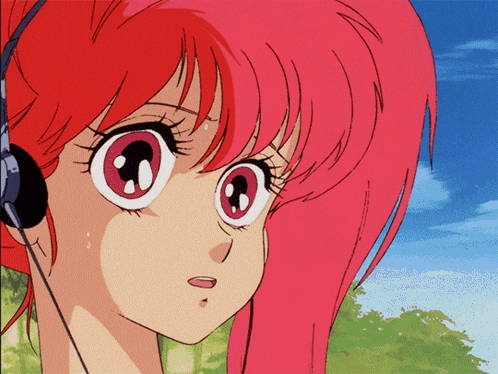 a girl with red hair wearing headphones looks to the side