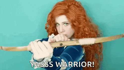 a woman with red hair is holding a bow and arrow and says yasss warrior !