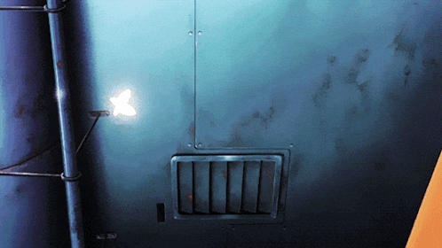 a blue wall with a light shining through a hole