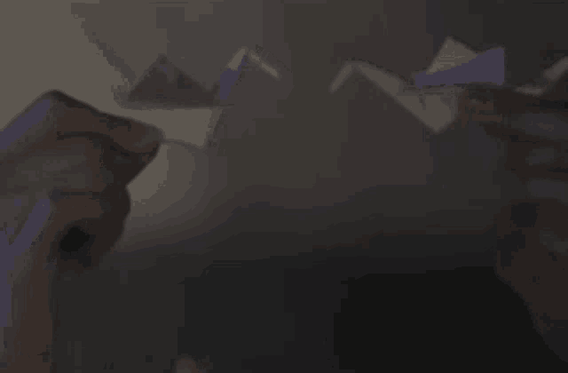 a person holding a piece of paper in their hands