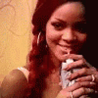 a woman with red hair is holding a can of soda in her hand .