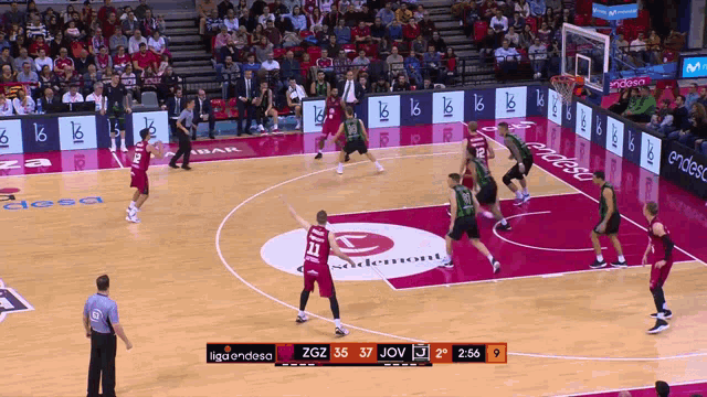 a basketball game is being played in a stadium with a scoreboard that says liga endesa at the top
