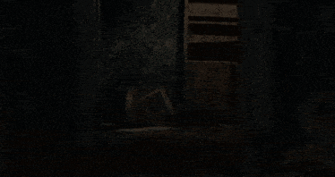 a person is standing in a dark room with smoke coming out of the walls