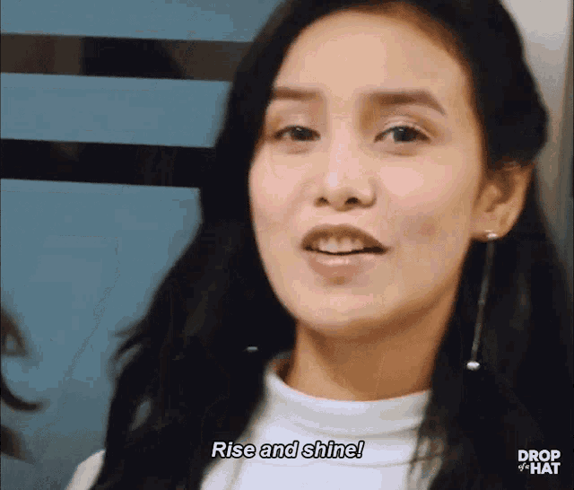 a close up of a woman 's face with the words rise and shine above her