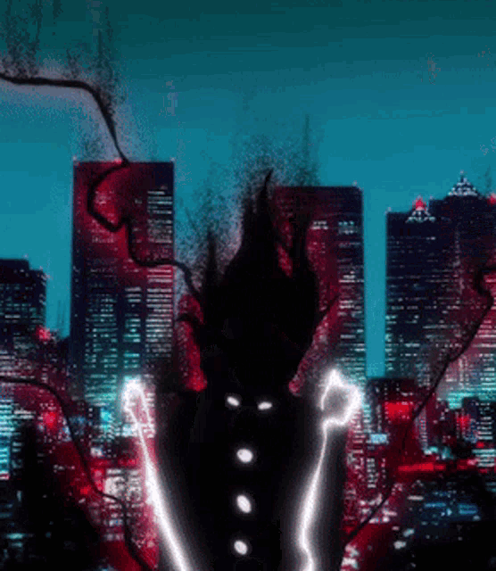 a silhouette of a person standing in front of a city at night