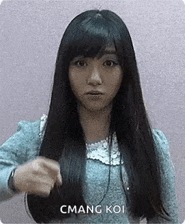a woman with long black hair is holding her hair in a blue dress .