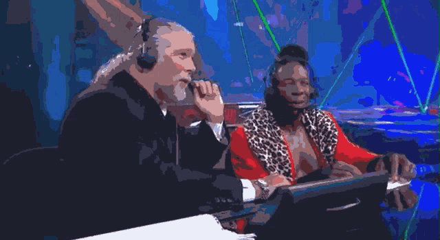 a man and a woman wearing headphones are sitting at a table