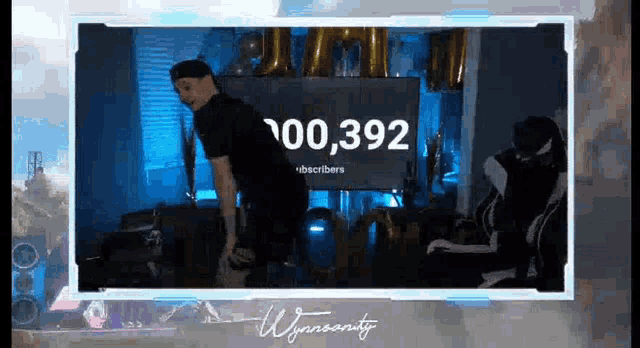 a man is standing in front of a screen that says `` 100,390 subscribers '' .