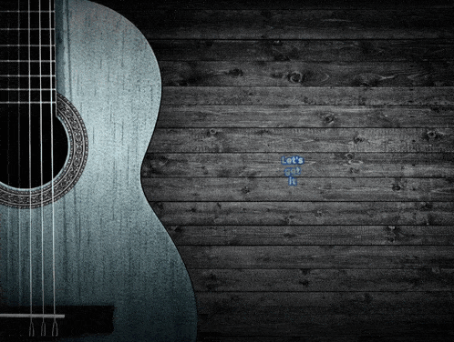 a guitar against a wooden wall with the words let 's do it