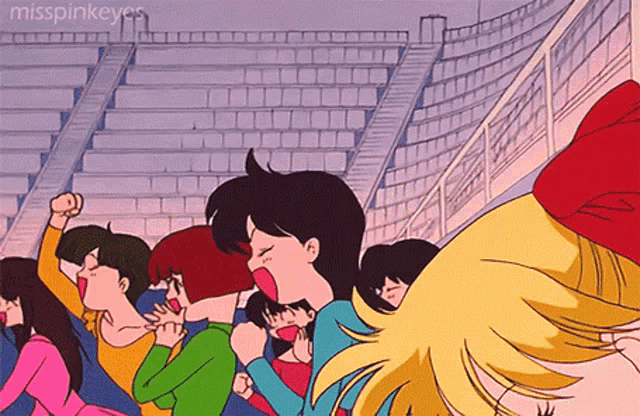 a group of people sitting in a stadium with the words misspinkeyes on the bottom right