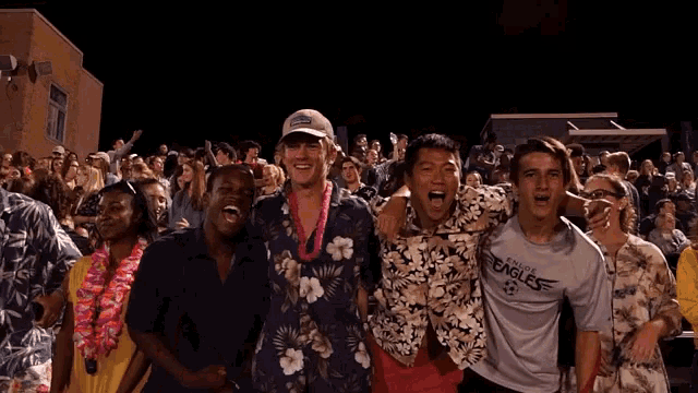 a group of people are posing for a picture and one of them is wearing a eagles shirt