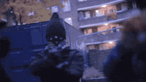 a blurry picture of a person standing in front of a building at night