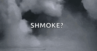 a black and white photo of smoke coming out of a hole in the sky .