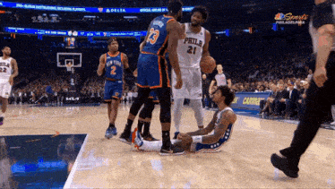 a philadelphia basketball player lays on the floor during a game