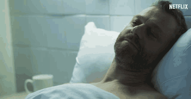 a man laying in a hospital bed with a netflix logo on the bottom
