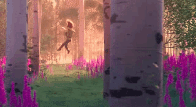 a girl is running through a forest with purple flowers .