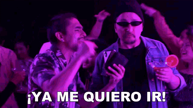 a group of men are dancing in a dark room and one of them says no