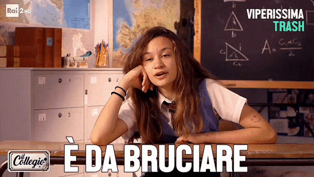 a girl sits at a desk with the words " e da bruciare " on the bottom