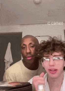 two men are standing next to each other with cameo written on the ceiling above them