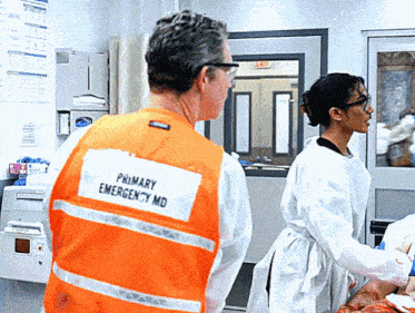 a man in an orange vest that says primary emergency md on it