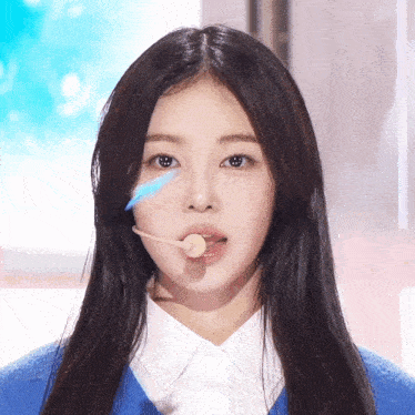 a girl with a microphone in her mouth