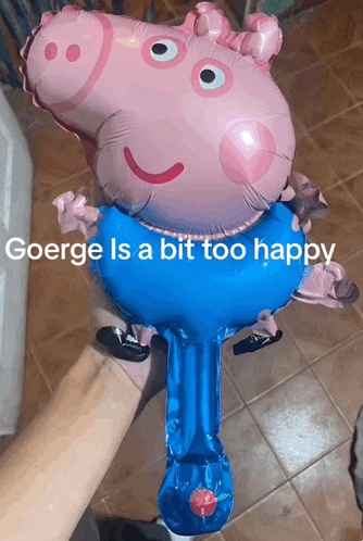 a person is holding a peppa pig balloon that says george is a bit too happy