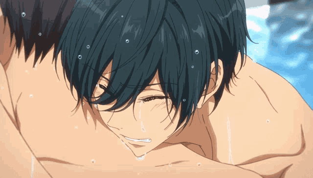 a man with blue hair is laying on another man 's chest